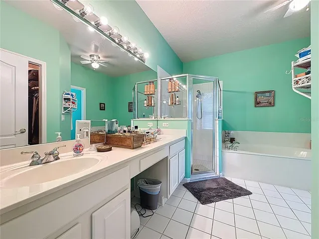 a bathroom with a tub a sink and a shower
