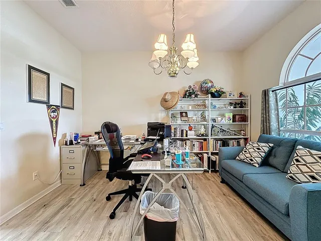 a view of a livingroom with workspace and a window