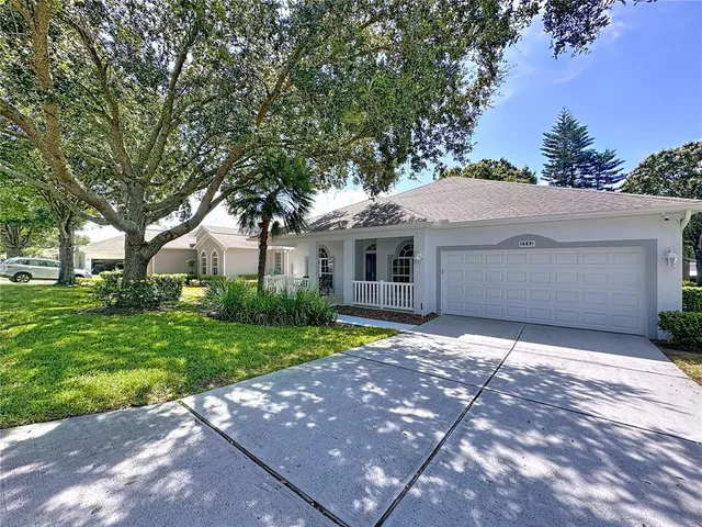 a front view of a house with a yard and a garage