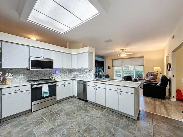 a view of house with yard and swimming pool