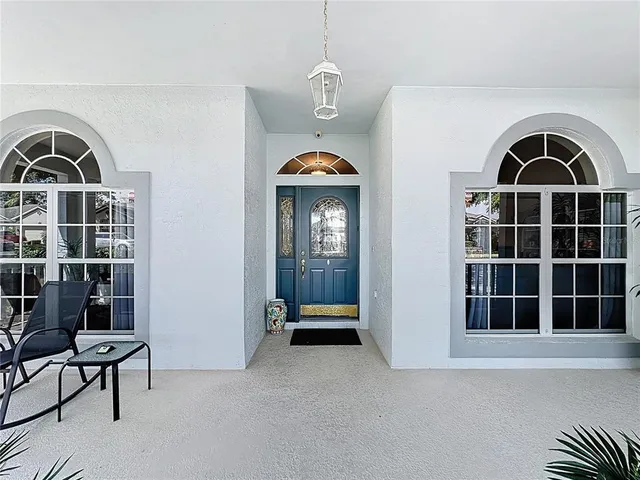 a kitchen with a table chairs refrigerator and cabinets
