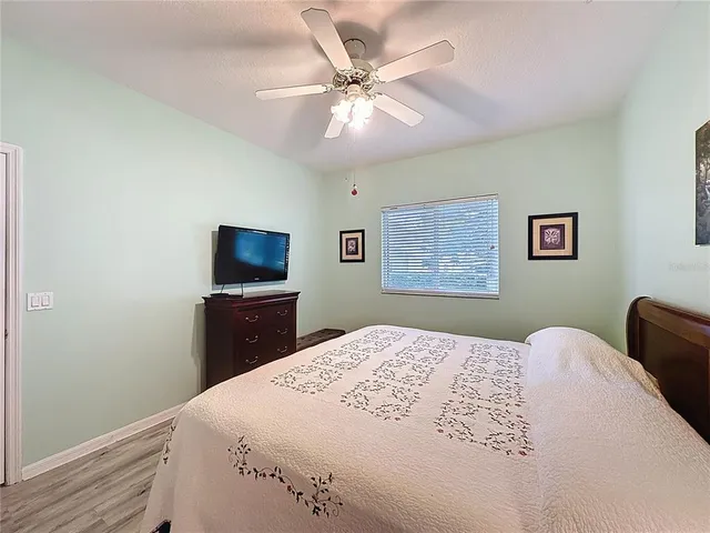 a bedroom with a large bed and a flat screen tv