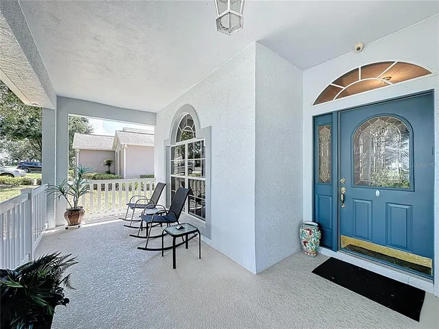 a lobby with furniture and a flat screen tv