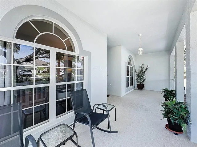 a view of swimming pool with outdoor seating and lake