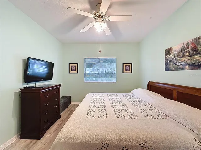 a spacious bedroom with two beds and a large window