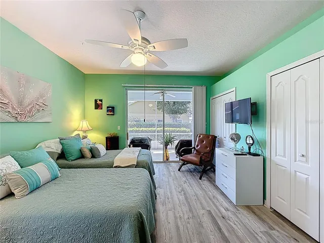 a living room with furniture a large window and a chandelier