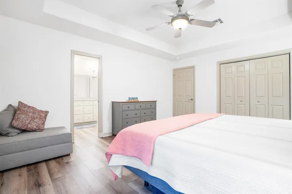 a bedroom with a bed and a couch