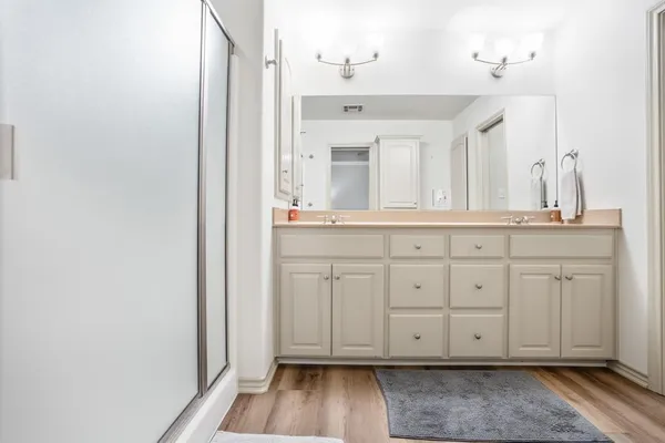 a view of a kitchen with white cabinets