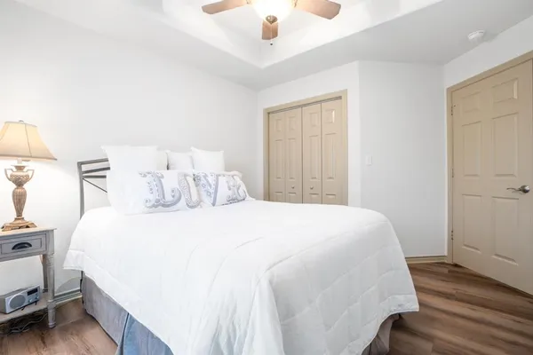 a bedroom with a bed and a chandelier