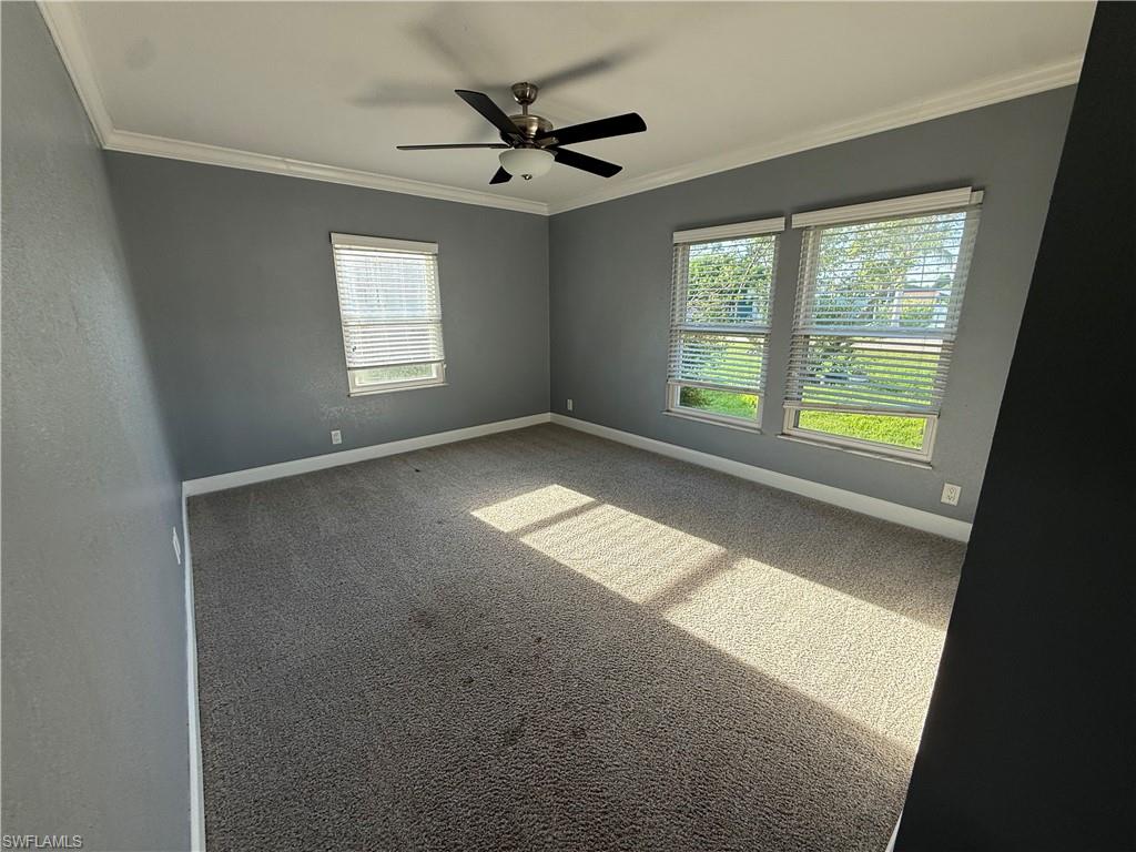 9169 Shaddock Road East Fort Myers, FL 33967 - Photo 4 of 8 Spacious room with gray wall finishes, crown molding, and plush carpeting