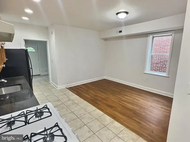 a kitchen with stainless steel appliances granite countertop a refrigerator sink and cabinets