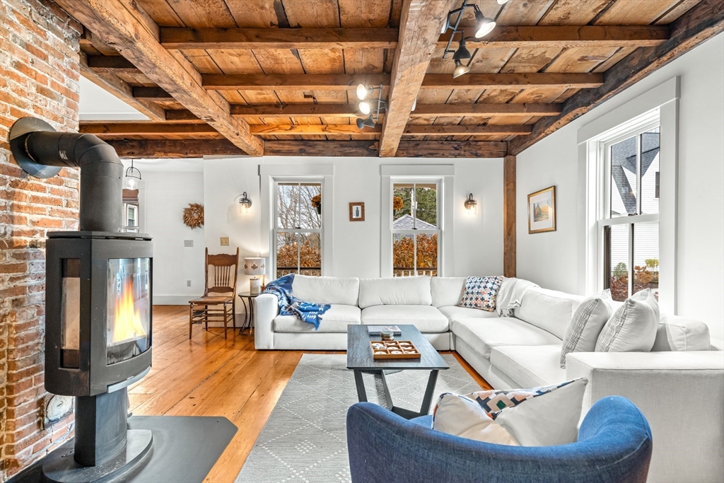 9 Chapman Avenue Andover, MA 01810 - Photo 14 of 39 a living room with furniture and a chandelier
