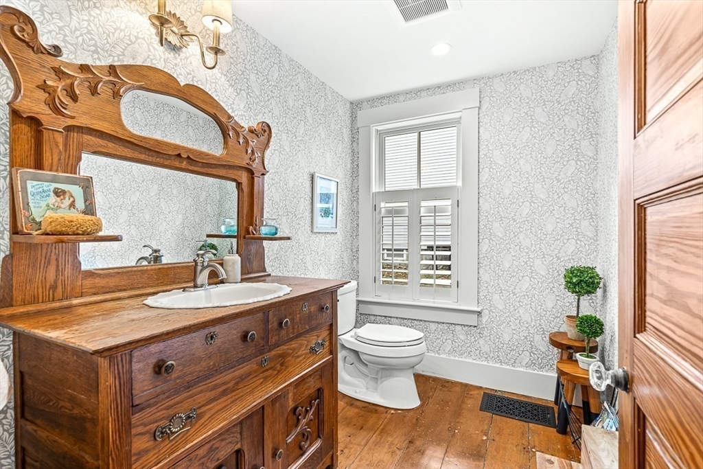 9 Chapman Avenue Andover, MA 01810 - Photo 19 of 39 a spacious bathroom with a granite countertop sink a toilet a mirror and a window