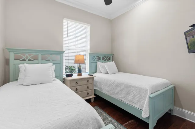 an aerial view of residential houses with outdoor space and trees