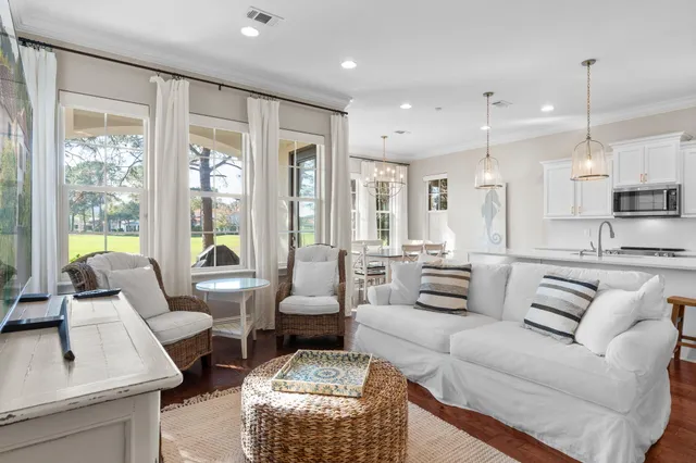 a dining room with furniture a chandelier and wooden floor