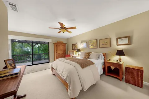 a spacious bedroom with a bed and a large window