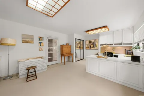 a kitchen with furniture and a refrigerator