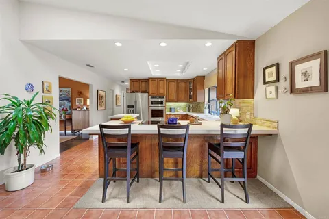 a kitchen with a table and chairs in it