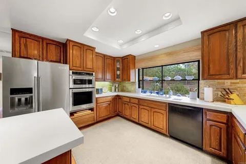 a kitchen with granite countertop stainless steel appliances and sink
