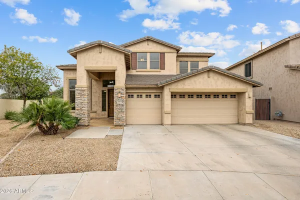 a view of a house with a yard and garage