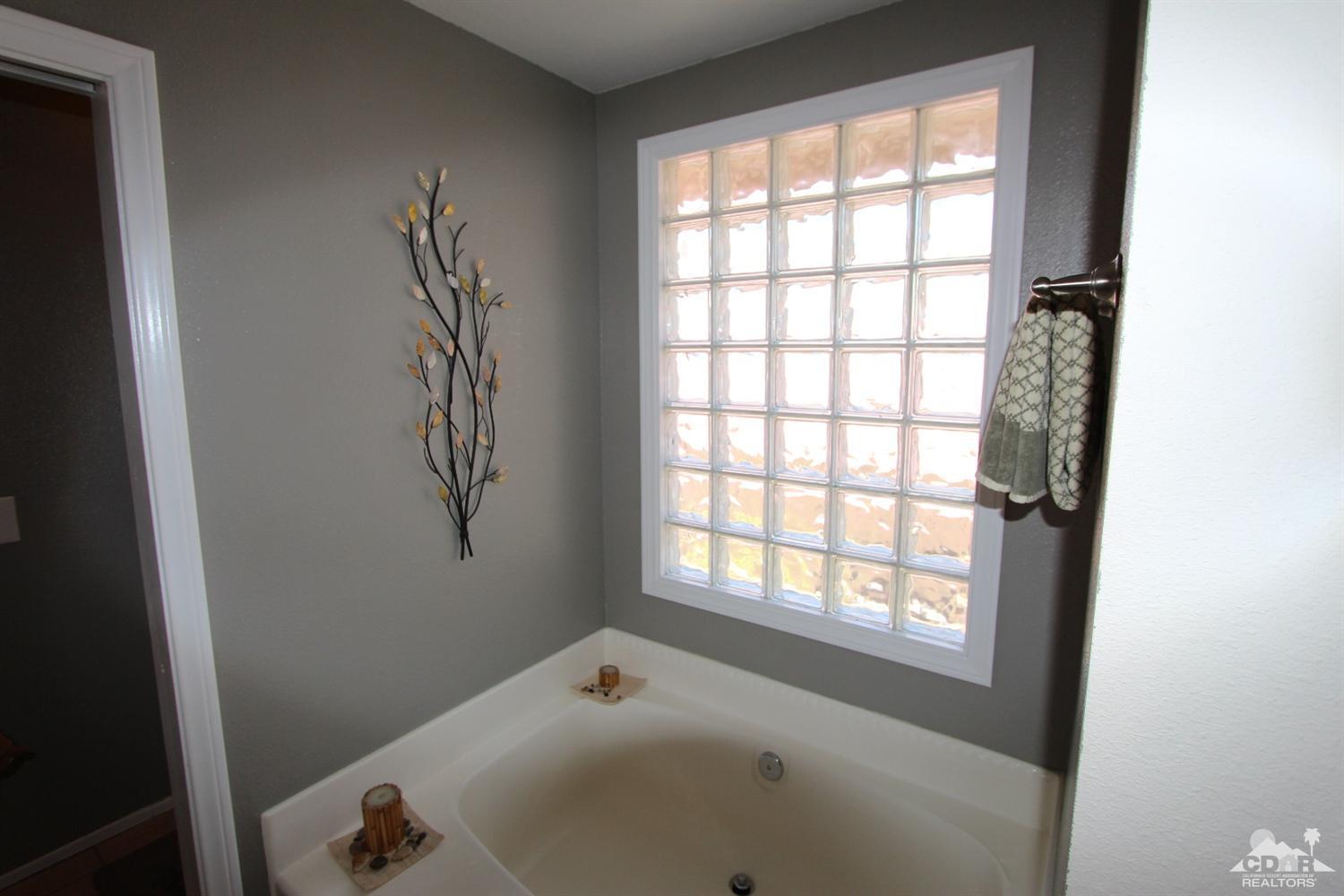 68335 Risueno Road Cathedral City, CA 92234 - Photo 27 of 32 a bathroom with a bathtub and shower