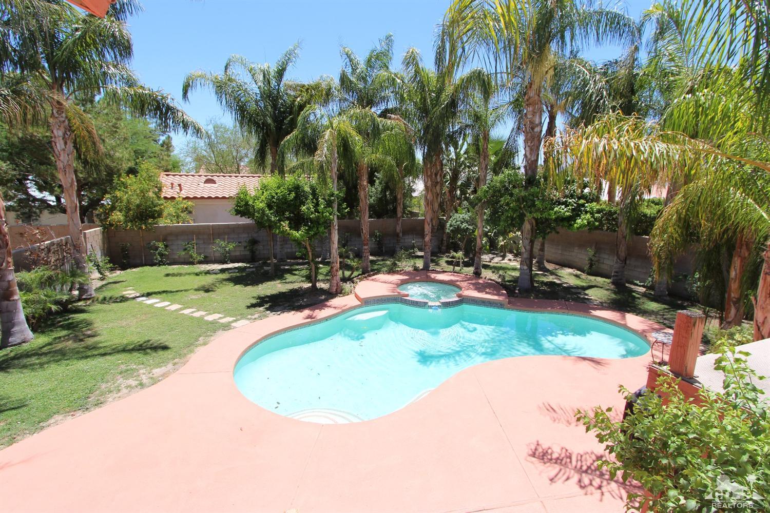 68335 Risueno Road Cathedral City, CA 92234 - Photo 3 of 32 a view of a backyard with a fountain plants and swimming pool