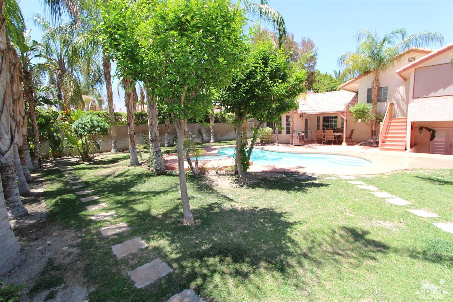 68335 Risueno Road Cathedral City, CA 92234 - Photo 31 of 32 a view of a house with a yard and tree s