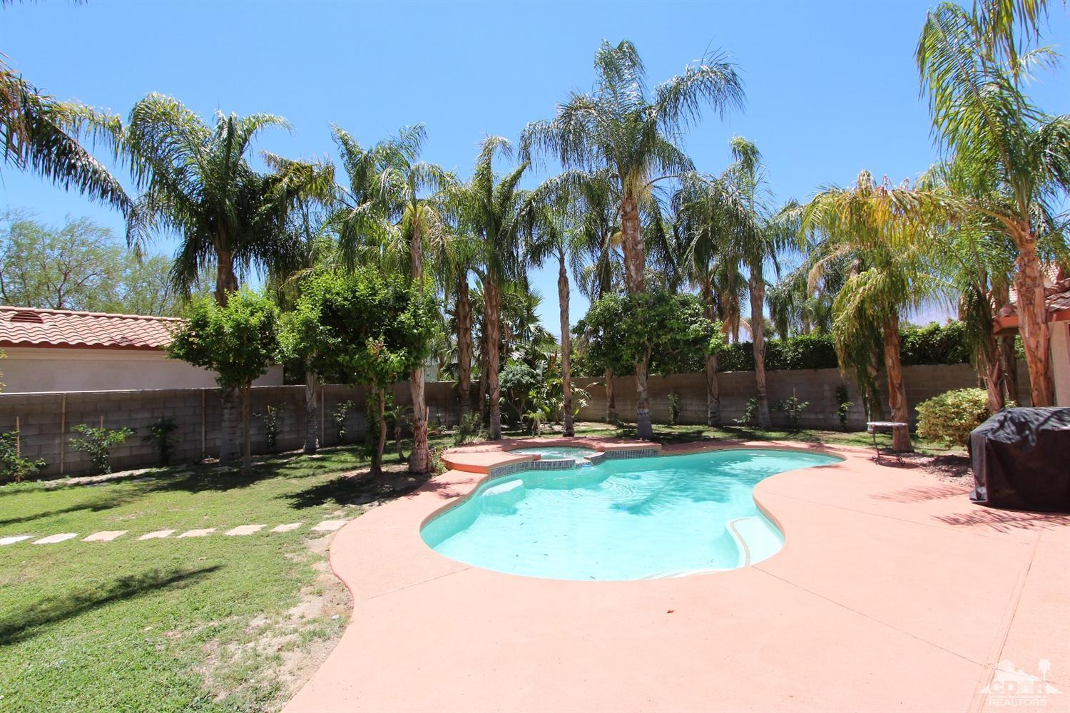 68335 Risueno Road Cathedral City, CA 92234 - Photo 4 of 32 a view of a swimming pool with a garden