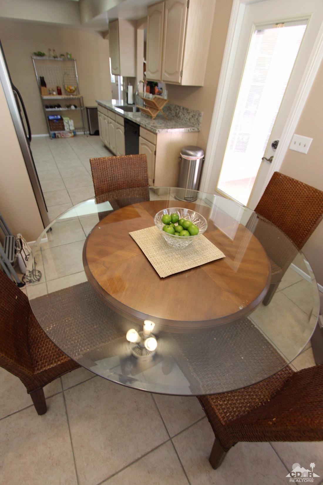 68335 Risueno Road Cathedral City, CA 92234 - Photo 10 of 32 a living room with table and chairs