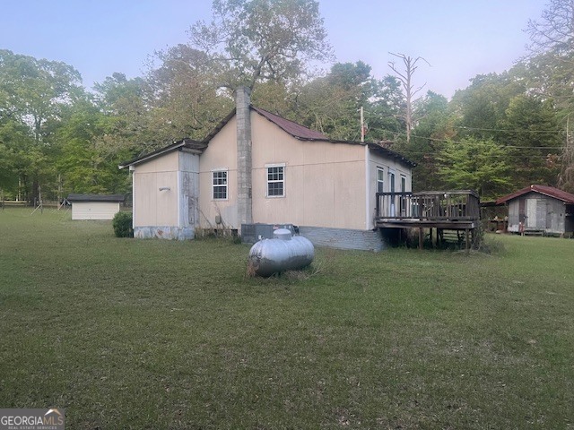 9742 South Sparta Davisboro Road Warthen, GA 31094 - Photo 21 of 39 a backyard of a house with table and chairs