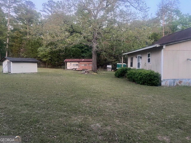 9742 South Sparta Davisboro Road Warthen, GA 31094 - Photo 23 of 39 a view of a house with a yard and garage