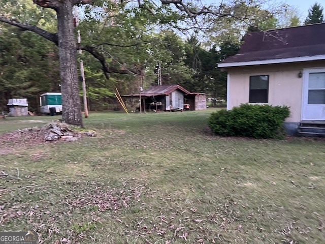 9742 South Sparta Davisboro Road Warthen, GA 31094 - Photo 28 of 39 a view of a house with a yard
