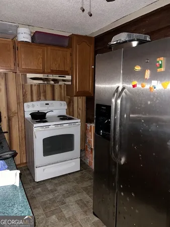 a kitchen with a stove and a refrigerator
