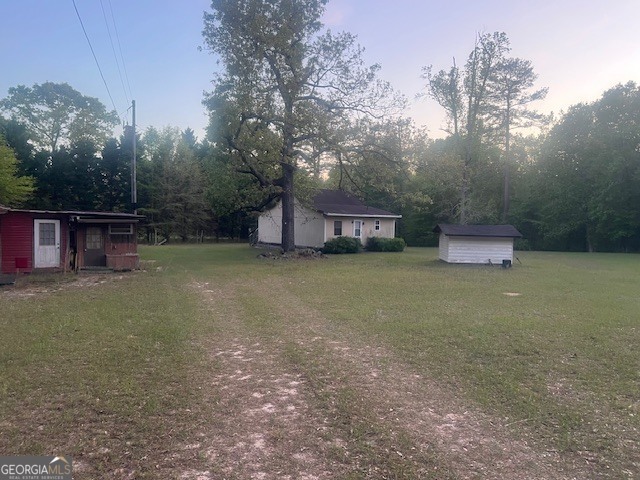 9742 South Sparta Davisboro Road Warthen, GA 31094 - Photo 5 of 39 a view of a house with a yard and sitting area