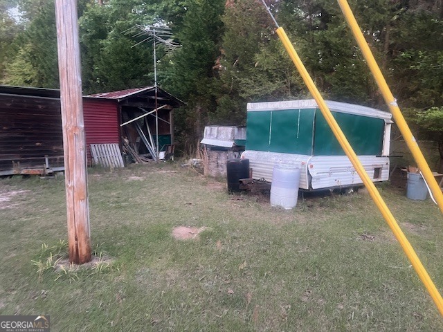 9742 South Sparta Davisboro Road Warthen, GA 31094 - Photo 10 of 39 a view of a wooden deck and a yard