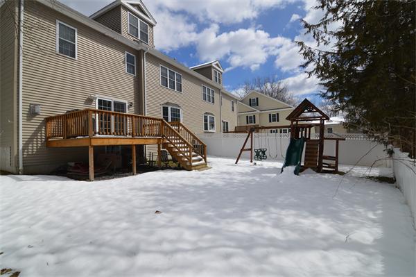 115 Booth Street, Unit 115 Needham, MA 02494 - Photo 14 of 15 a view of a house with a snow in the yard