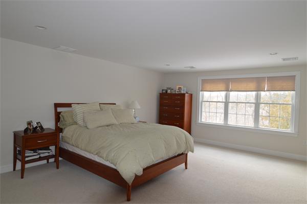 115 Booth Street, Unit 115 Needham, MA 02494 - Photo 6 of 15 a bedroom with a bed and a couch
