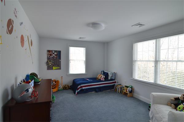 115 Booth Street, Unit 115 Needham, MA 02494 - Photo 8 of 15 a room with toys and a window