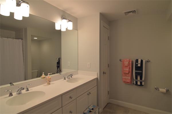 115 Booth Street, Unit 115 Needham, MA 02494 - Photo 10 of 15 a bathroom with a sink vanity and a mirror