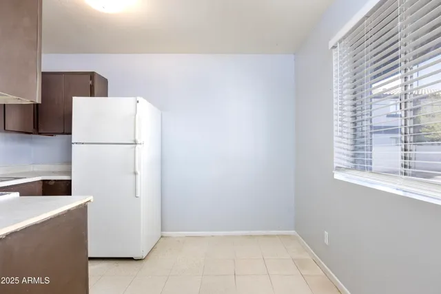 a white refrigerator freezer sitting inside of a kitchen