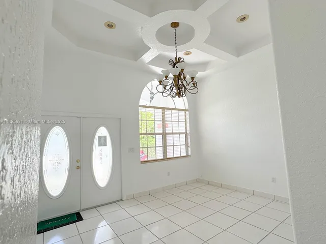 an empty room with wooden floor and mirror