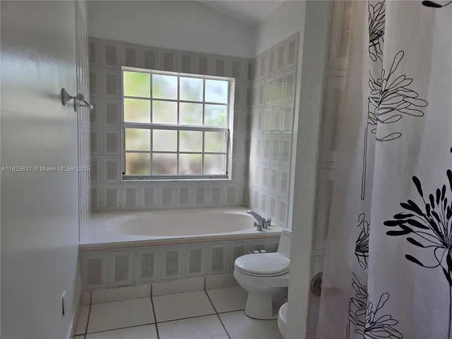 a bathroom with a toilet and a bathtub