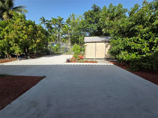 a view of a house with a yard and garage