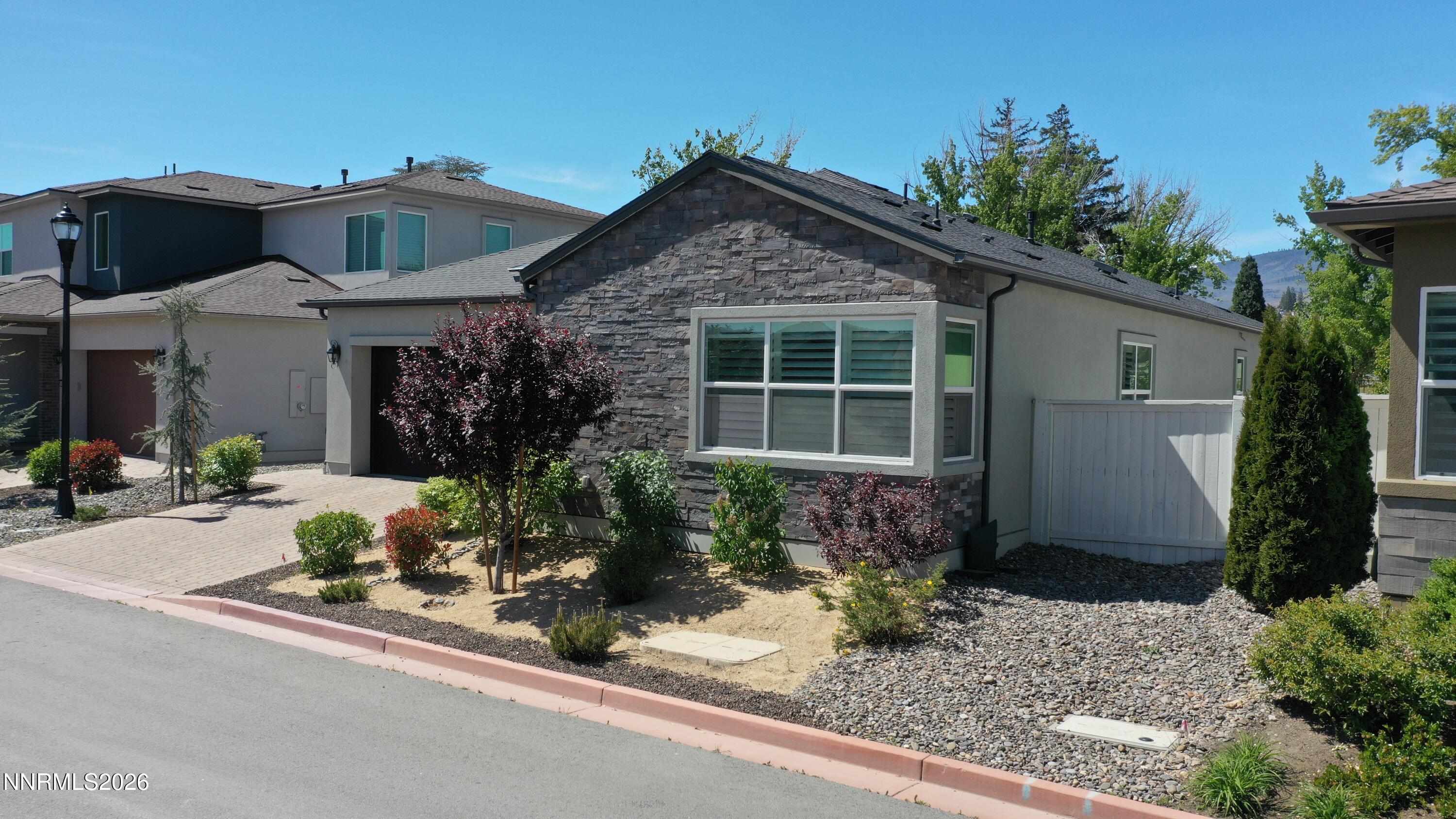 5513 Western Rider Trail Reno, NV 89511 - Photo 1 of 36 a front view of a house with garden