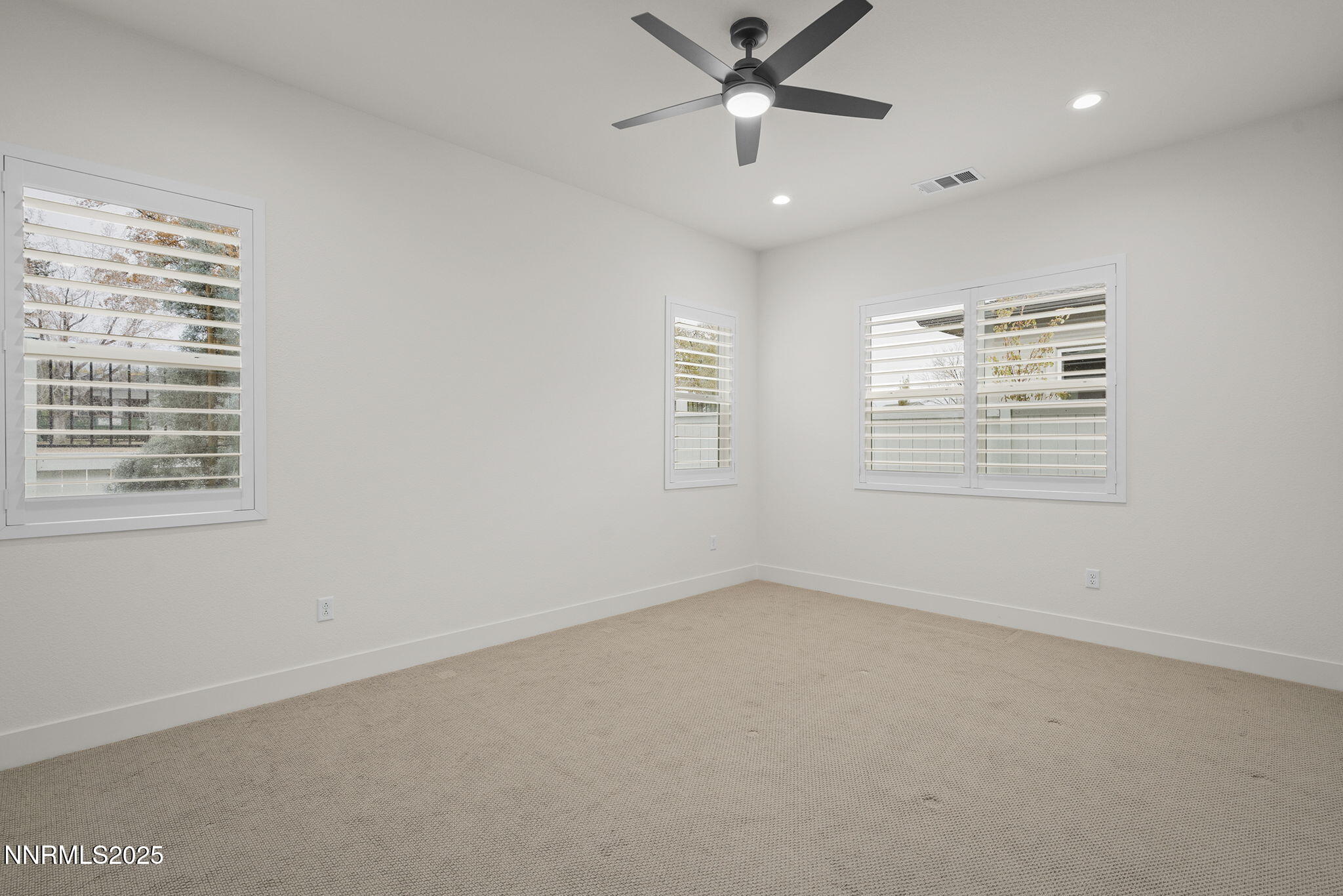 5513 Western Rider Trail Reno, NV 89511 - Photo 12 of 36 an empty room with windows and fan
