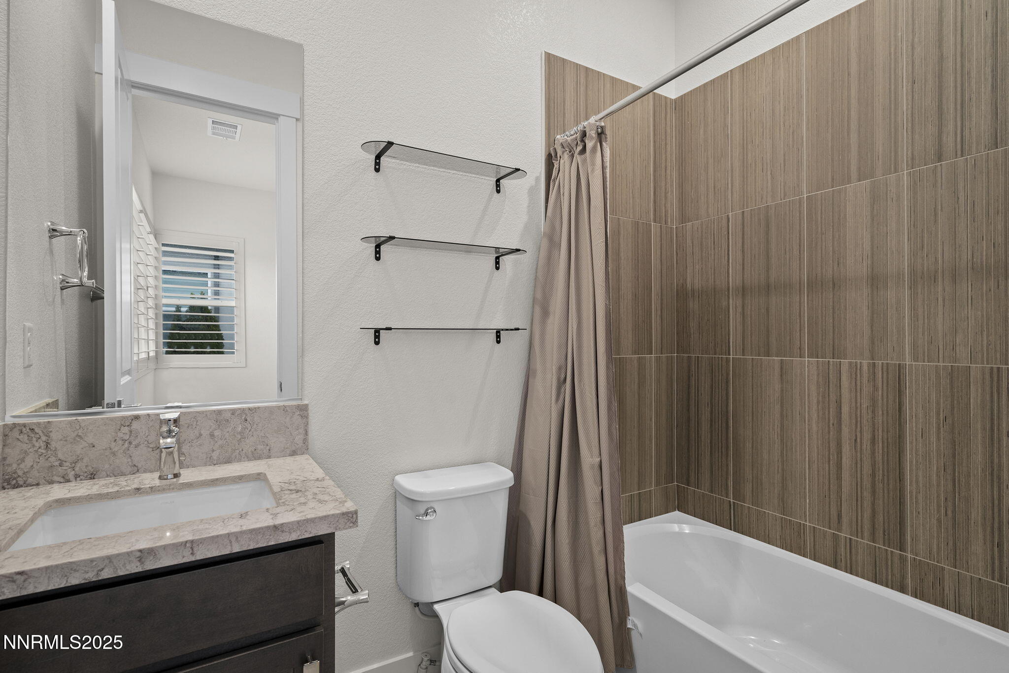 5513 Western Rider Trail Reno, NV 89511 - Photo 18 of 36 a bathroom with a granite countertop bathtub sink vanity mirror and toilet