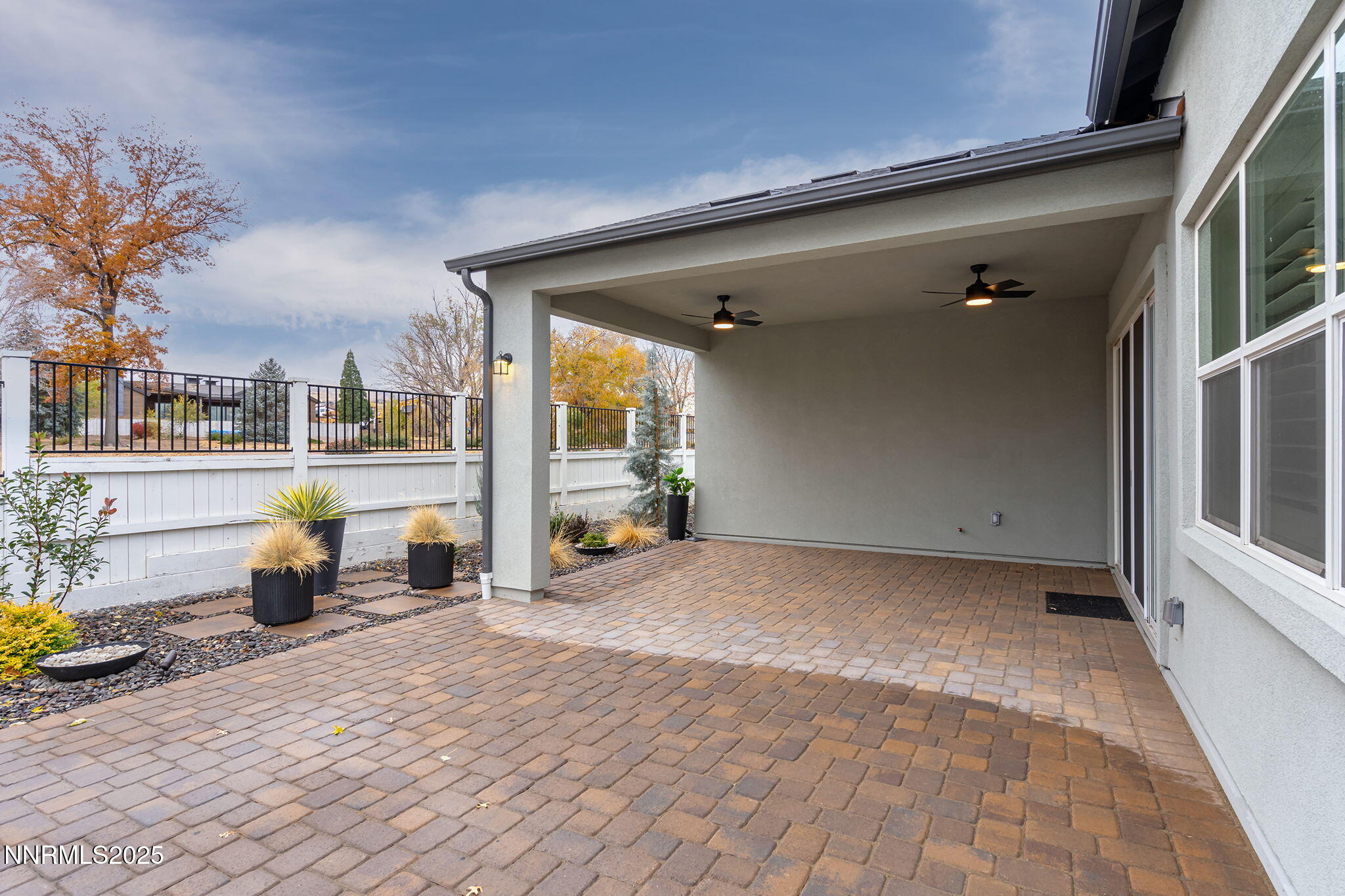 5513 Western Rider Trail Reno, NV 89511 - Photo 23 of 36 a view of a patio with a table and chairs and potted plants