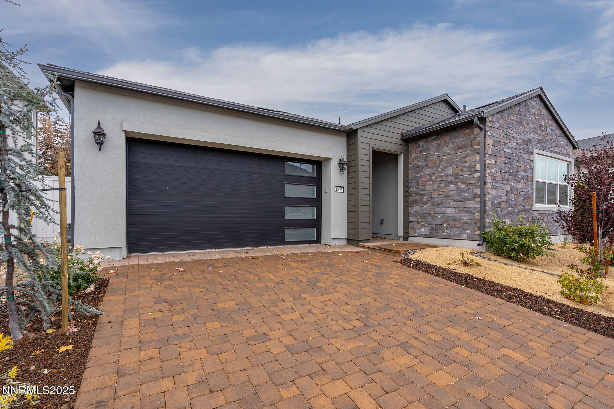 5513 Western Rider Trail Reno, NV 89511 - Photo 3 of 36 a front view of a house with a yard and garage
