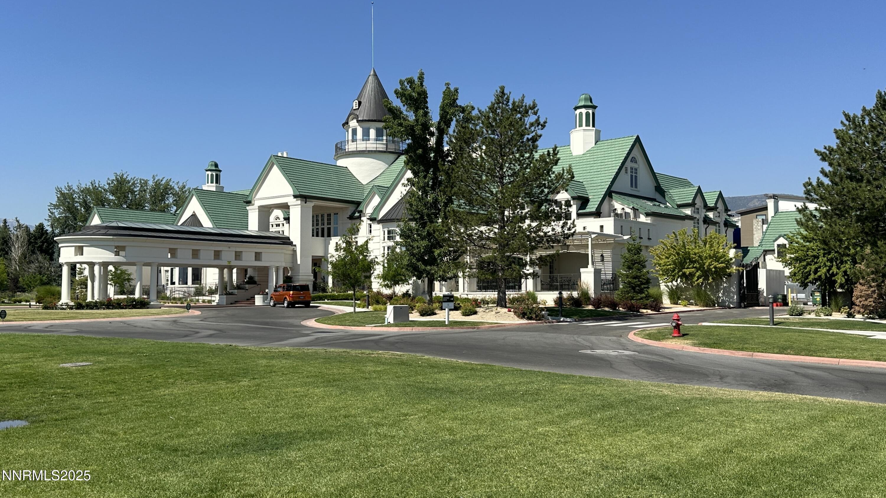5513 Western Rider Trail Reno, NV 89511 - Photo 33 of 36 a front view of a building with garden and trees