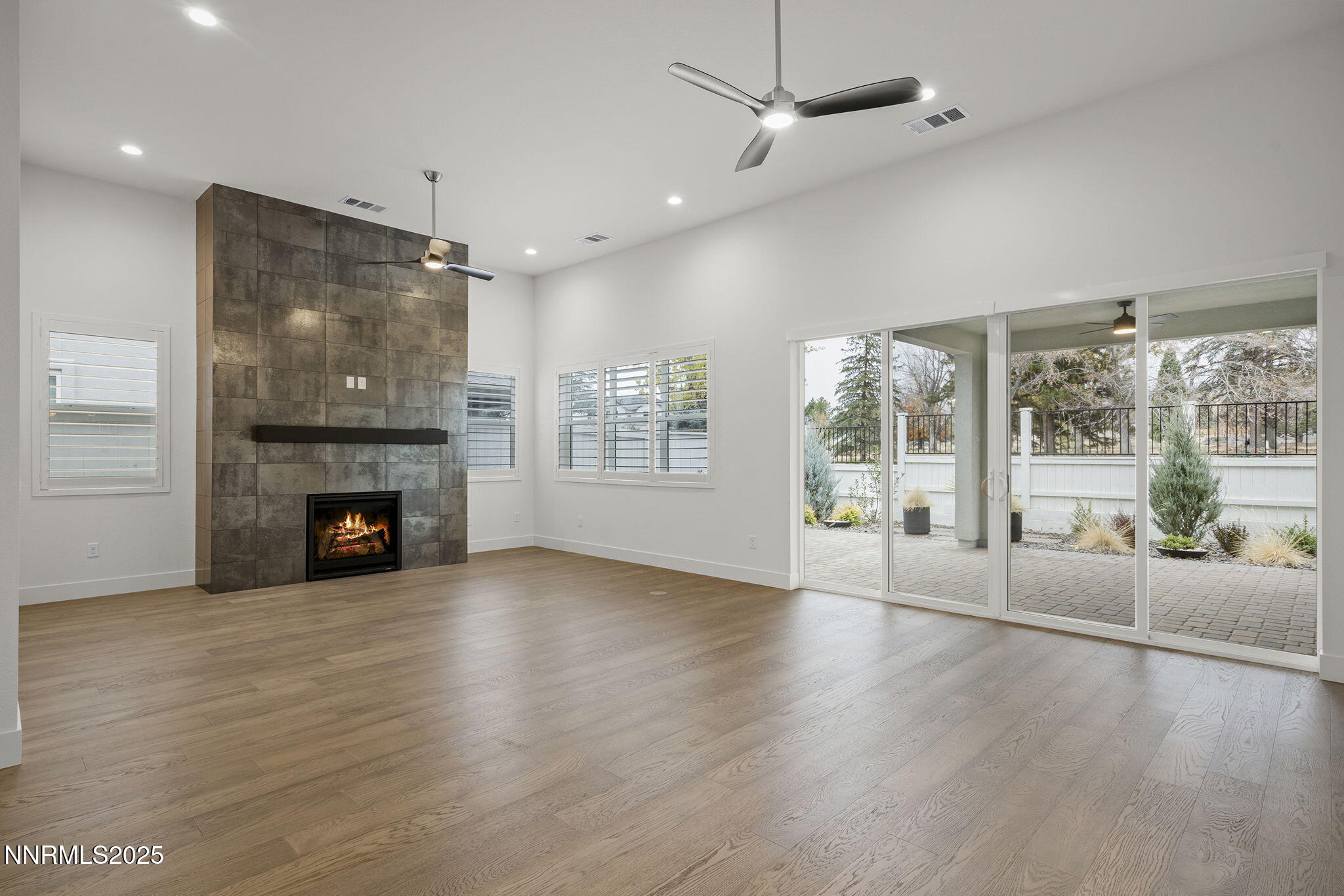 5513 Western Rider Trail Reno, NV 89511 - Photo 6 of 36 a view of an empty room with wooden floor and a fireplace